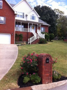 Pansies, black mulch, and elbow grease make this front yard shine!